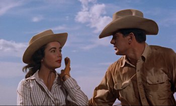 Movie still from “Giant” (1956), directed by George Stevens – A man and a woman wearing cowboy hats; Medium shot, Low angle