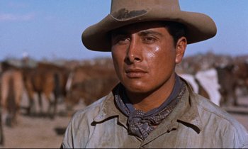 Movie still from “Giant” (1956), directed by George Stevens – A man with a cowboy hat on in the desert; Close Up shot, Low angle
