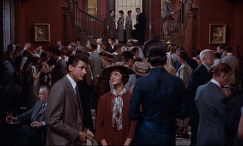 Movie still from “Giant” (1956), directed by George Stevens – A group of people standing in a room; Wide shot, Low angle
