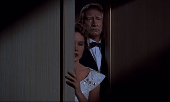 Movie still from “Giant” (1956), directed by George Stevens – A man and a woman standing next to each other in a room; Medium shot, Low angle