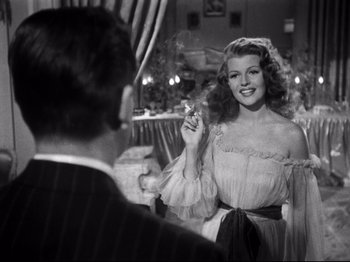 Movie still from “Gilda” (1946), directed by Charles Vidor – An old photo of a woman smoking a cigarette in front of a man; Medium shot, Over the shoulder angle