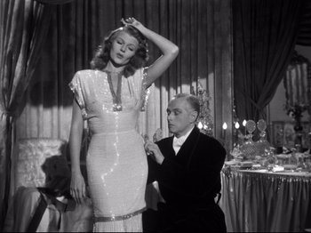 Movie still from “Gilda” (1946), directed by Charles Vidor – An old photo of a man and a woman posing for a picture; Medium shot, Low angle