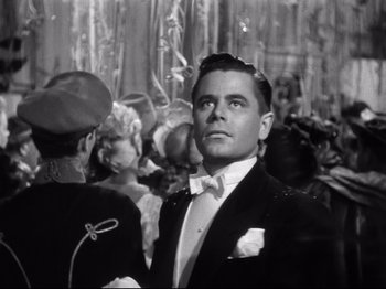 Movie still from “Gilda” (1946), directed by Charles Vidor – A black and white photo of a man in a tuxedo; Close Up shot, Low angle