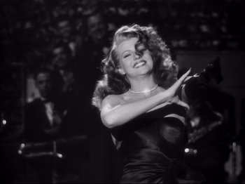 Movie still from “Gilda” (1946), directed by Charles Vidor – A black and white photo of a woman in a black dress; Medium shot, Low angle