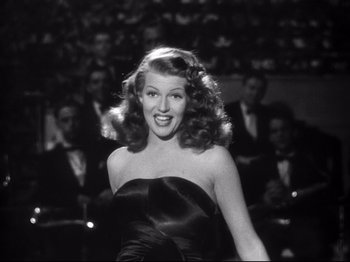 Movie still from “Gilda” (1946), directed by Charles Vidor – A black and white photo of a woman in a black dress; Medium shot, Low angle