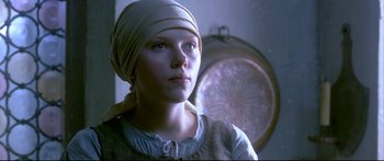 Movie still from “Girl with a Pearl Earring” (2003), directed by Peter Webber – A young woman wearing a head scarf and looking into the distance; Close Up shot, Low angle