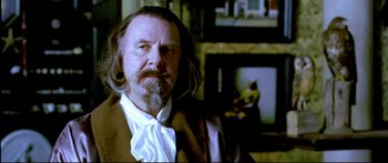 Movie still from “Girl with a Pearl Earring” (2003), directed by Peter Webber – A man with long hair and a beard wearing an old - fashioned suit; Close Up shot, Over the shoulder angle