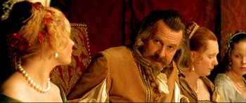 Movie still from “Girl with a Pearl Earring” (2003), directed by Peter Webber – A person sitting on a chair; Close Up shot, Over the shoulder angle