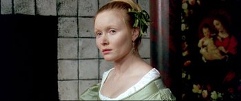 Movie still from “Girl with a Pearl Earring” (2003), directed by Peter Webber – A woman with a green bow in her hair; Close Up shot, High angle