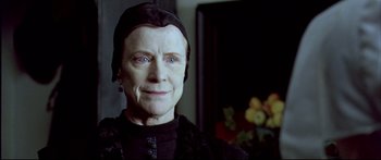 Movie still from “Girl with a Pearl Earring” (2003), directed by Peter Webber – An older woman wearing a black outfit and a black hat; Close Up shot, Low angle