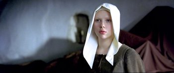 Movie still from “Girl with a Pearl Earring” (2003), directed by Peter Webber – A young woman wearing a white head covering; Close Up shot, Low angle