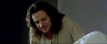 Movie still from “Girl with a Pearl Earring” (2003), directed by Peter Webber – A person with long black hair; Close Up shot, High angle