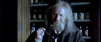 Movie still from “Girl with a Pearl Earring” (2003), directed by Peter Webber – An old man with long white beard holding a toothbrush; Close Up shot, Over the shoulder angle