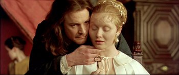 Movie still from “Girl with a Pearl Earring” (2003), directed by Peter Webber – A man and a woman are holding each other close; Close Up shot, Over the shoulder angle