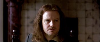 Movie still from “Girl with a Pearl Earring” (2003), directed by Peter Webber – A man with long brown hair and a beard; Close Up shot, Over the shoulder angle