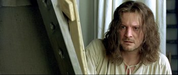 Movie still from “Girl with a Pearl Earring” (2003), directed by Peter Webber – A person with long brown hair; Close Up shot, High angle