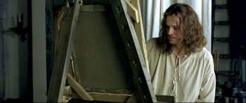 Movie still from “Girl with a Pearl Earring” (2003), directed by Peter Webber – A man with long brown hair standing in front of an open window; Close Up shot, High angle