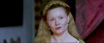 Movie still from “Girl with a Pearl Earring” (2003), directed by Peter Webber – A person with long blonde hair; Close Up shot, High angle