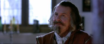 Movie still from “Girl with a Pearl Earring” (2003), directed by Peter Webber – An older man with long hair and a beard; Close Up shot, Over the shoulder angle