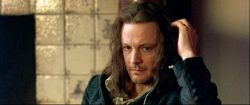 Movie still from “Girl with a Pearl Earring” (2003), directed by Peter Webber – A person with long brown hair; Close Up shot, High angle