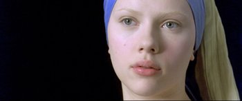 Movie still from “Girl with a Pearl Earring” (2003), directed by Peter Webber – A person wearing a blue head scarf; Close Up shot, Overhead angle