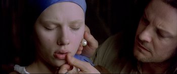 Movie still from “Girl with a Pearl Earring” (2003), directed by Peter Webber – A person touching a woman's face with her hand; Extreme Close Up shot, Over the shoulder angle