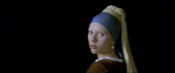 Movie still from “Girl with a Pearl Earring” (2003), directed by Peter Webber – A girl with a pearl earing is wearing a headdress; Close Up shot, Low angle