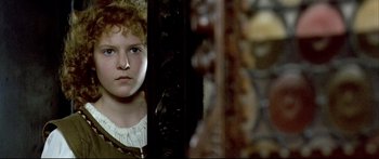 Movie still from “Girl with a Pearl Earring” (2003), directed by Peter Webber – A young girl looking at the camera through a window; Close Up shot, Over the shoulder angle