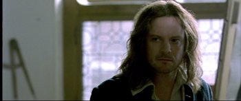 Movie still from “Girl with a Pearl Earring” (2003), directed by Peter Webber – A person with long dark hair; Close Up shot, Over the shoulder angle