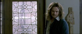 Movie still from “Girl with a Pearl Earring” (2003), directed by Peter Webber – A man standing in front of a window; Close Up shot, Over the shoulder angle