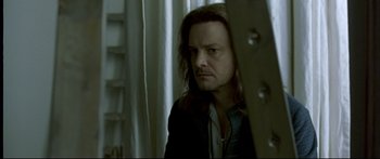 Movie still from “Girl with a Pearl Earring” (2003), directed by Peter Webber – A man with long brown hair is looking at the camera; Close Up shot, Low angle