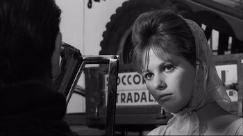Movie still from “Girl with a Suitcase” (1961), directed by Valerio Zurlini – A young woman with a hair piece looking into a mirror; Close Up shot, Over the shoulder angle