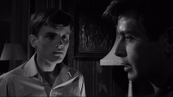 Movie still from “Girl with a Suitcase” (1961), directed by Valerio Zurlini – A man and a boy are looking at each other; Close Up shot, Over the shoulder angle