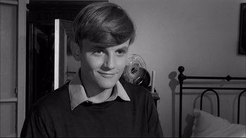Movie still from “Girl with a Suitcase” (1961), directed by Valerio Zurlini – A young man in a room with a fan in the background; Close Up shot, High angle