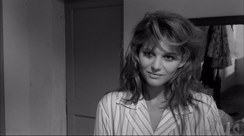 Movie still from “Girl with a Suitcase” (1961), directed by Valerio Zurlini – A black - and - white photo of a woman in pajamas; Close Up shot, Over the shoulder angle