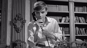 Movie still from “Girl with a Suitcase” (1961), directed by Valerio Zurlini – A young man is holding a phone to his ear; Close Up shot, Low angle