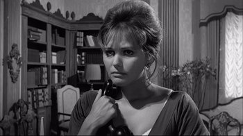 Movie still from “Girl with a Suitcase” (1961), directed by Valerio Zurlini – A black and white photo of a woman holding a phone; Close Up shot, Low angle