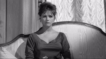 Movie still from “Girl with a Suitcase” (1961), directed by Valerio Zurlini – A black and white photo of a woman sitting in front of a window; Close Up shot, High angle