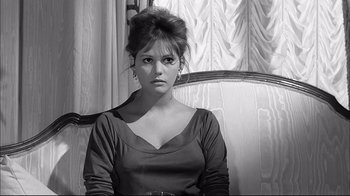 Movie still from “Girl with a Suitcase” (1961), directed by Valerio Zurlini – A black - and - white photo of a woman sitting in a chair; Close Up shot, High angle