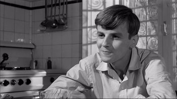 Movie still from “Girl with a Suitcase” (1961), directed by Valerio Zurlini – A young man in a white dress shirt is smiling; Close Up shot, Over the shoulder angle