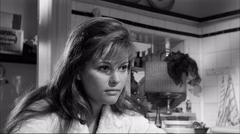 Movie still from “Girl with a Suitcase” (1961), directed by Valerio Zurlini – A black - and - white photo of a woman looking at the camera; Close Up shot, Low angle