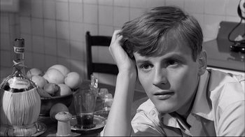 Movie still from “Girl with a Suitcase” (1961), directed by Valerio Zurlini – A man sitting at a table with his head resting on his hand; Close Up shot, High angle