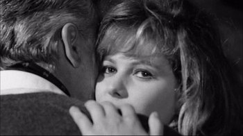 Movie still from “Girl with a Suitcase” (1961), directed by Valerio Zurlini – A man and a woman embracing each other in a black and white photo; Close Up shot, Over the shoulder angle