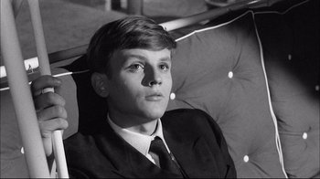 Movie still from “Girl with a Suitcase” (1961), directed by Valerio Zurlini – A man in a suit and tie sitting in front of a mirror; Close Up shot, High angle