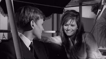 Movie still from “Girl with a Suitcase” (1961), directed by Valerio Zurlini – A young man and a young woman smile at each other; Close Up shot, Over the shoulder angle