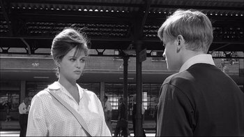 Movie still from “Girl with a Suitcase” (1961), directed by Valerio Zurlini – A woman standing next to a man in front of a building; Close Up shot, Over the shoulder angle