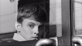 Movie still from “Girl with a Suitcase” (1961), directed by Valerio Zurlini – A young man looking out of a train window; Close Up shot, High angle