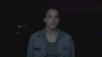 Movie still from “Girlfight” (2000), directed by Karyn Kusama – A woman in a gray shirt is looking at the camera; Close Up shot, Low angle