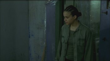 Movie still from “Girlfight” (2000), directed by Karyn Kusama – A woman standing in front of a mirror; Medium shot, Over the shoulder angle