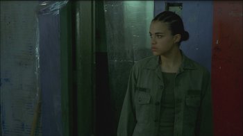 Movie still from “Girlfight” (2000), directed by Karyn Kusama – A young woman in a green shirt looking to her left; Close Up shot, Low angle